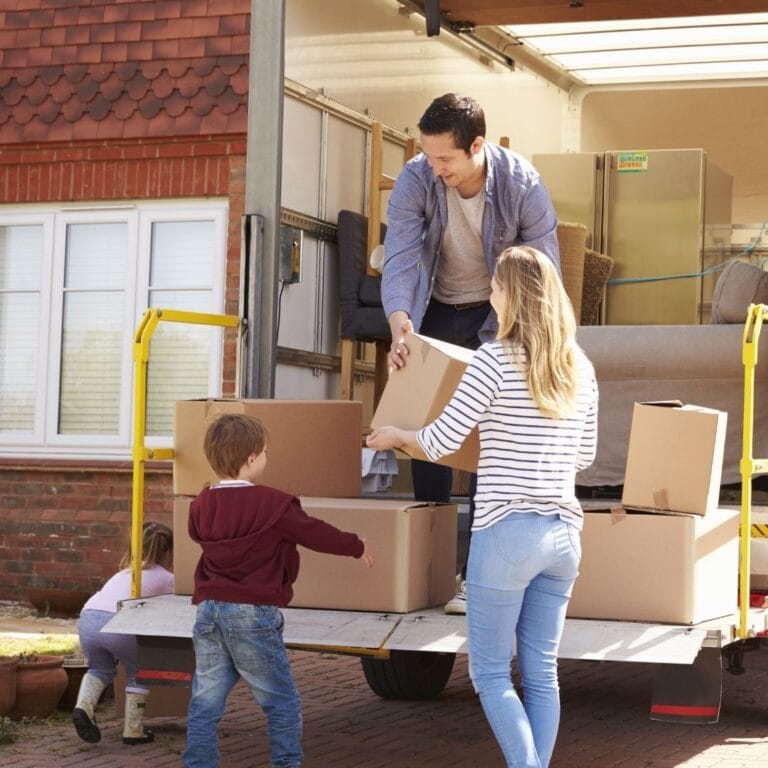 family helping load boxes on a moving truck