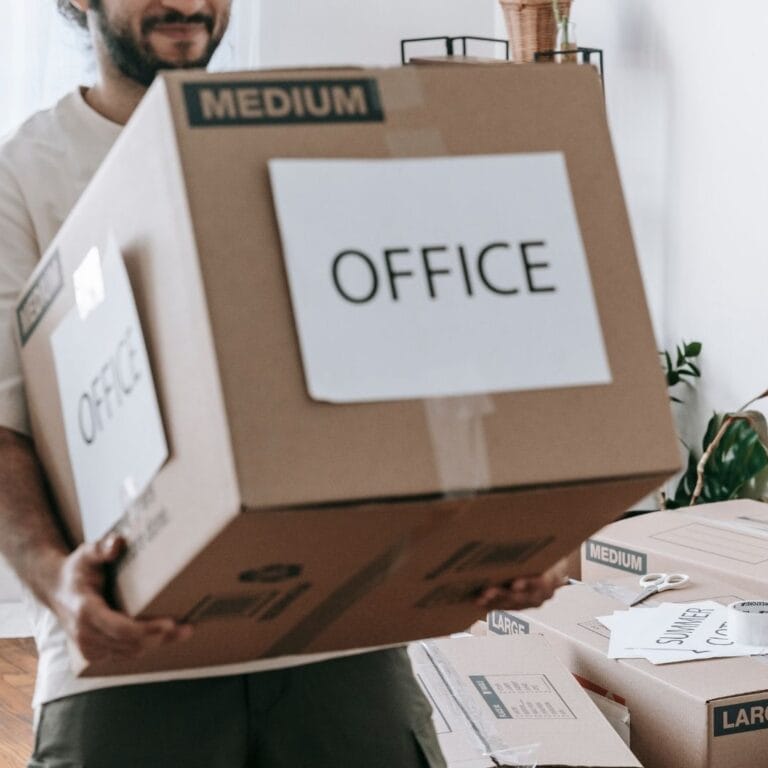 holding a moving box that says office
